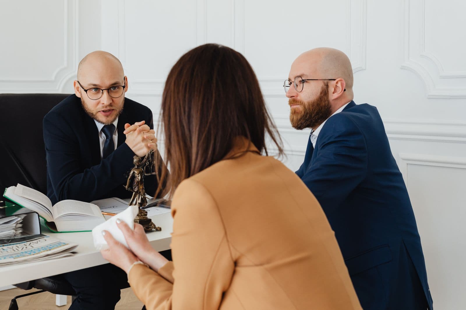 Two people reviewing paperwork together at a desk during a consultation