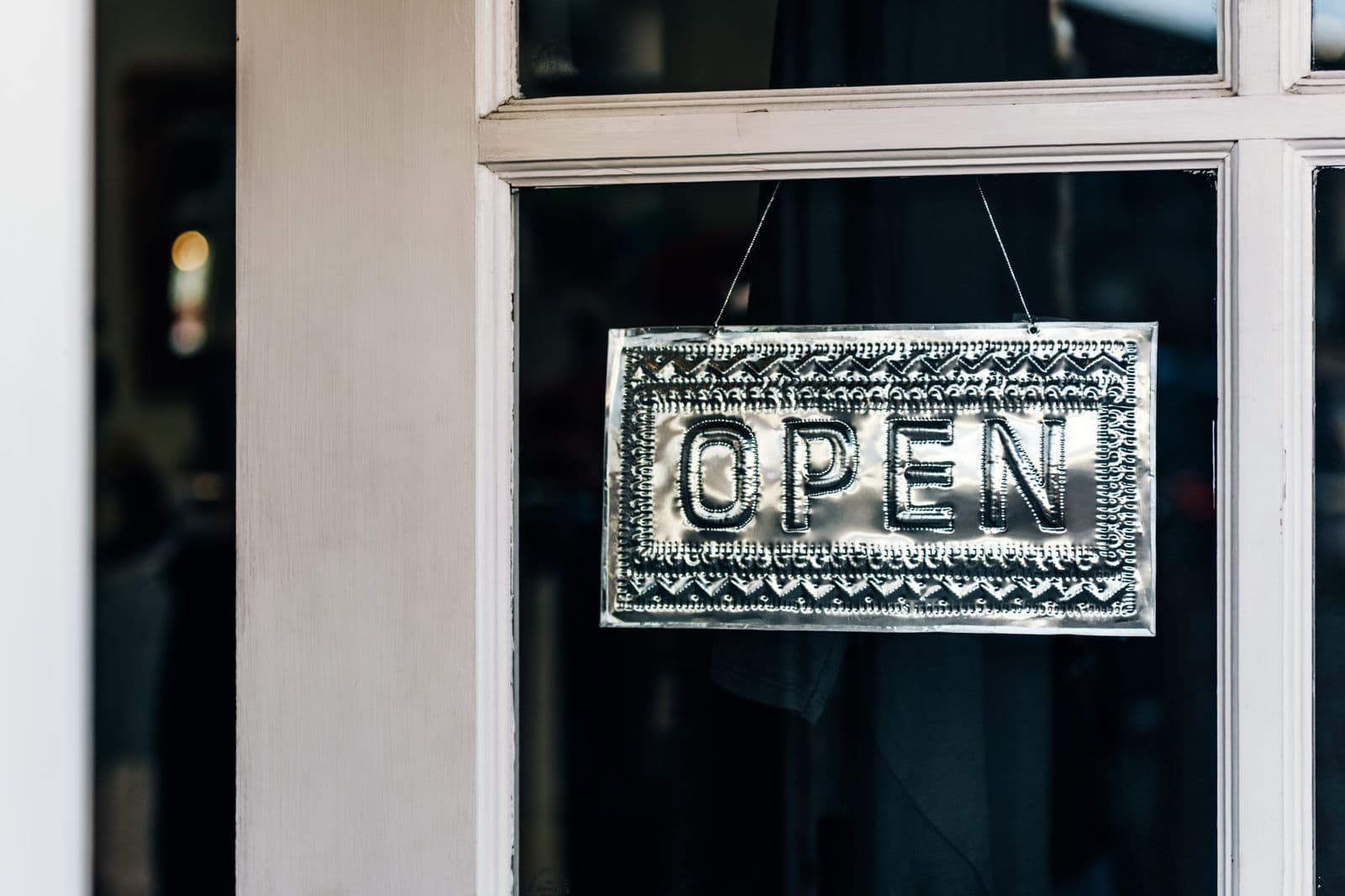A small business storefront with a sign hanging above the entrance