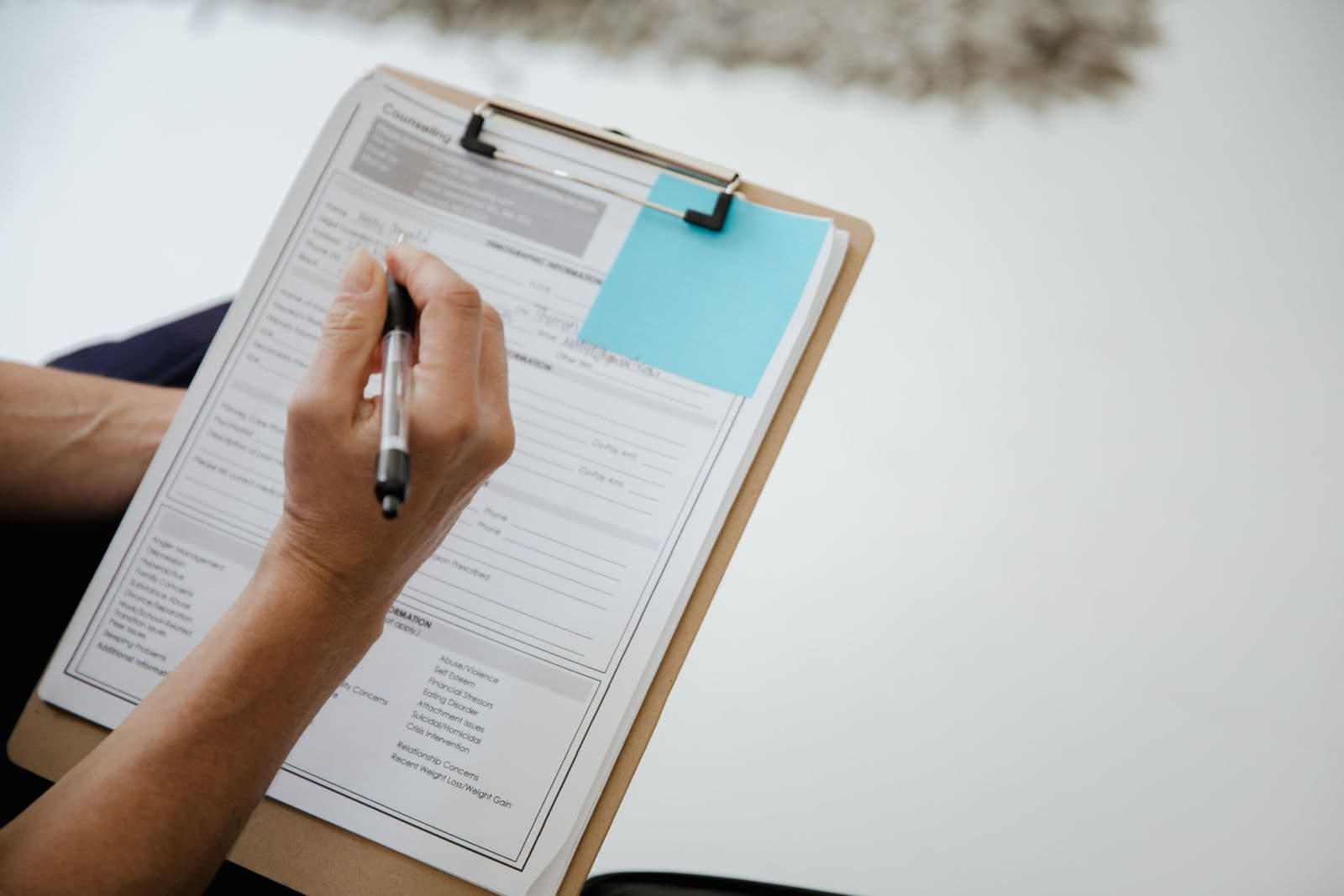 A checklist on a clipboard with a pen resting on top